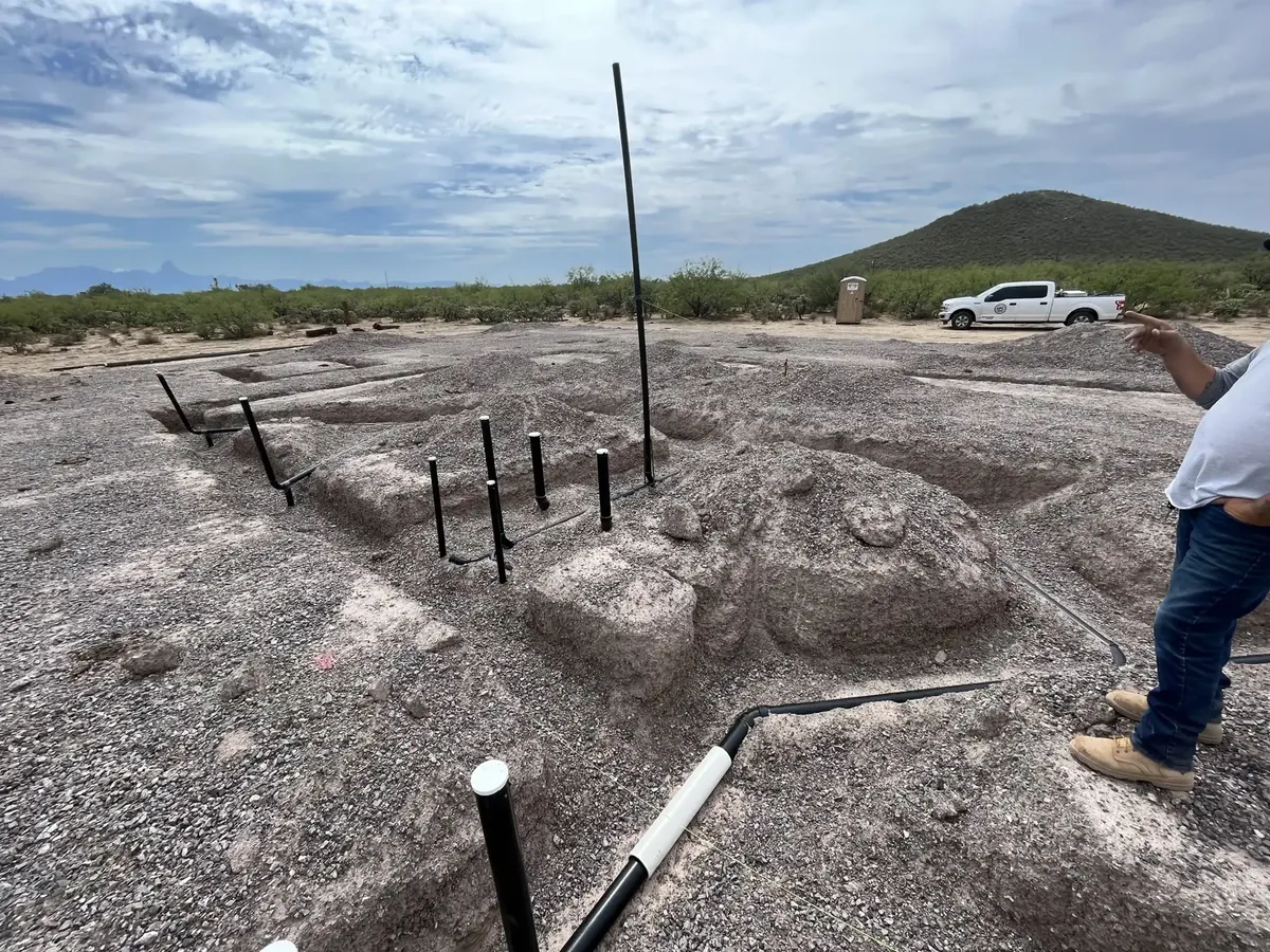 Underground plumbing rising through a prepared foundation area