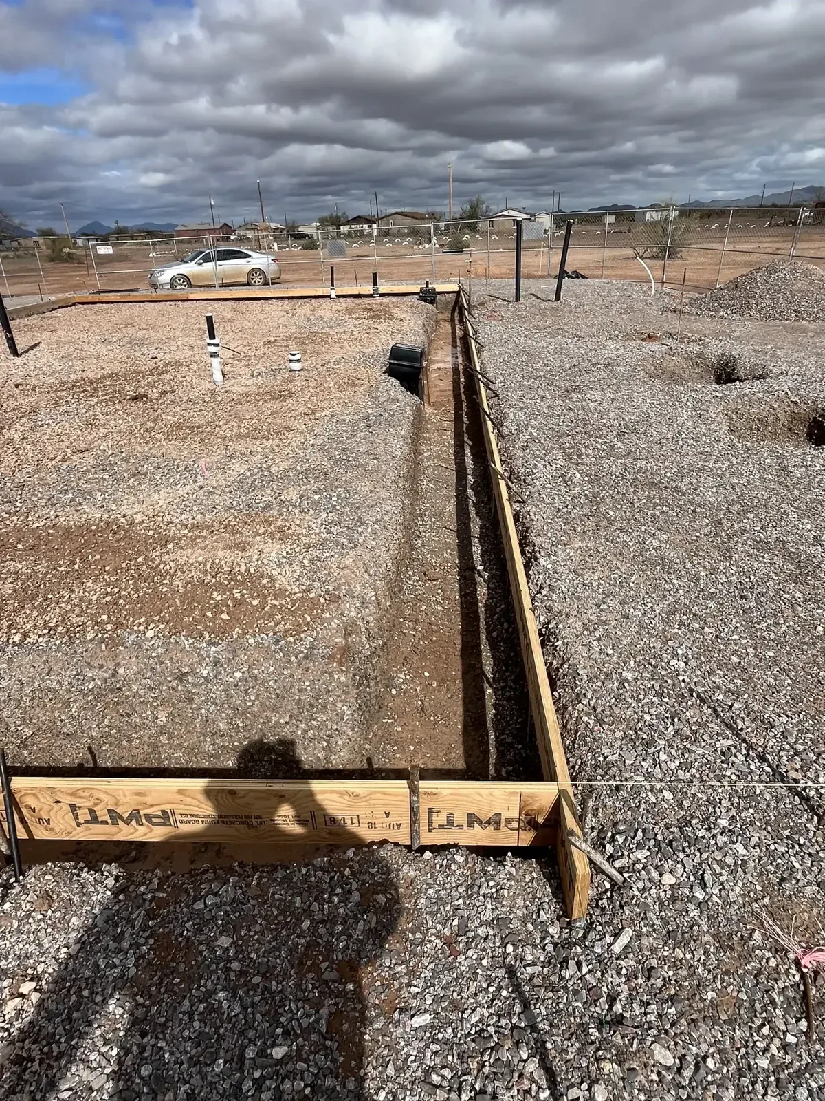 Long formed trench within a prepared building footprint