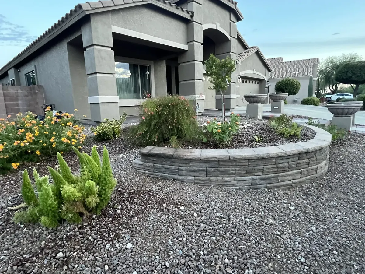 Low masonry landscape wall following a curved planting bed